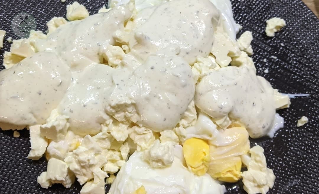 Pour yoghurt sauce on the poached eggs Pour yoghurt sauce on the poached eggs